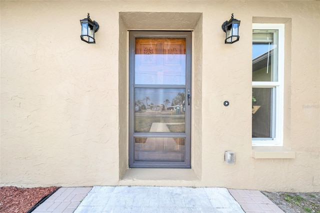 entrance to property with stucco siding