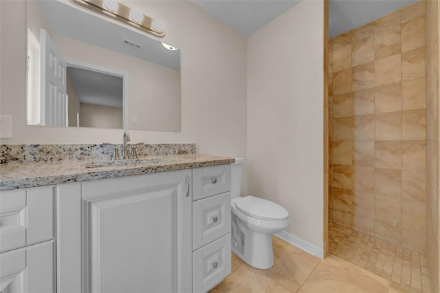 full bathroom featuring tile patterned flooring, visible vents, toilet, tiled shower, and vanity