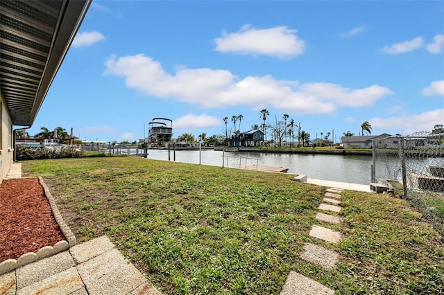 view of yard featuring fence and a water view