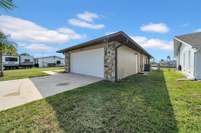 garage with central air condition unit, driveway, and fence