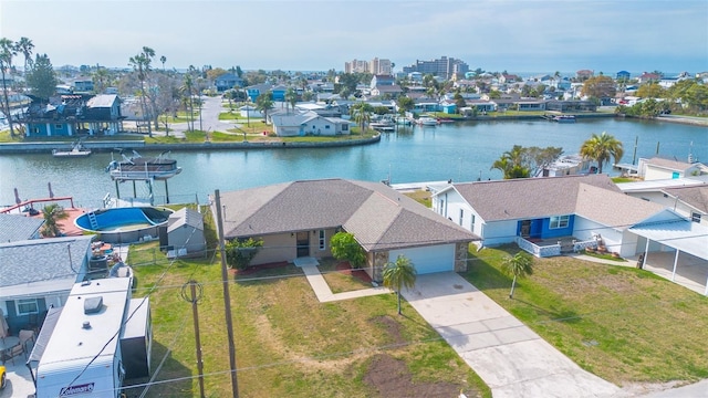 birds eye view of property with a residential view and a water view