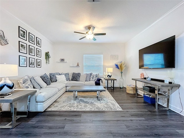 living room featuring dark wood-style floors, ornamental molding, a textured ceiling, and a ceiling fan