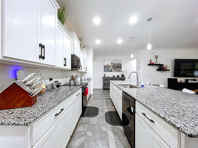 kitchen featuring light stone countertops, black appliances, white cabinetry, and a sink