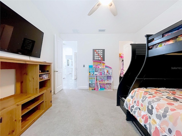 carpeted bedroom with baseboards, visible vents, and a ceiling fan