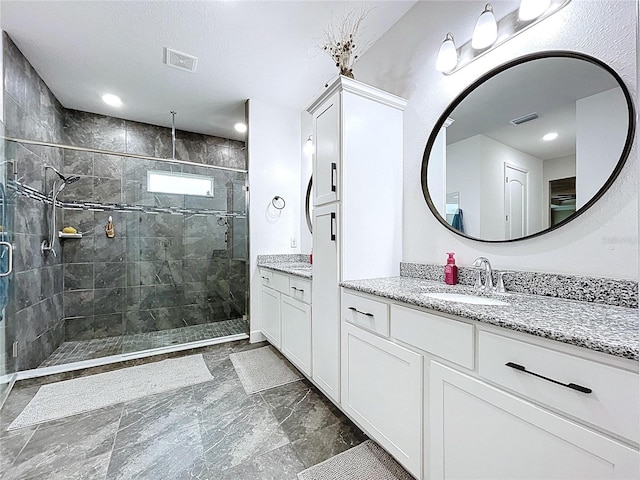 full bathroom with a stall shower, visible vents, marble finish floor, and vanity