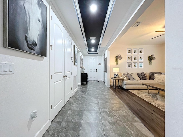 corridor featuring dark wood-style floors, baseboards, and visible vents