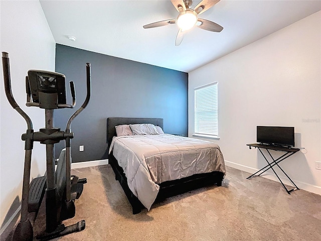 bedroom with ceiling fan, carpet flooring, and baseboards