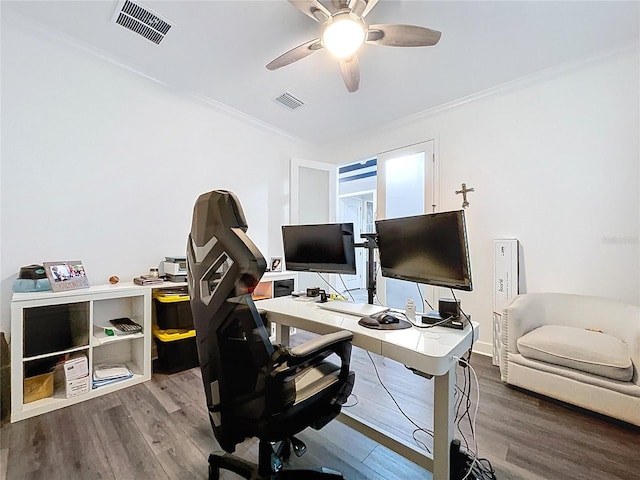 office space with ornamental molding, wood finished floors, visible vents, and a ceiling fan