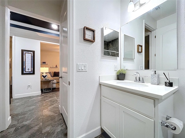 bathroom featuring visible vents, baseboards, and vanity