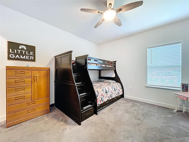 carpeted bedroom with baseboards and a ceiling fan