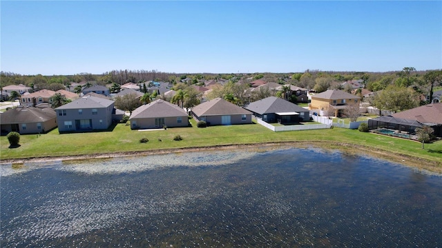 drone / aerial view featuring a residential view and a water view