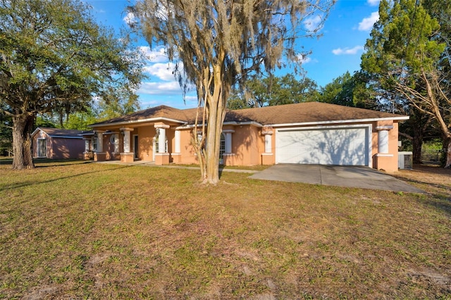 ranch-style home featuring a garage, central AC, driveway, stucco siding, and a front yard