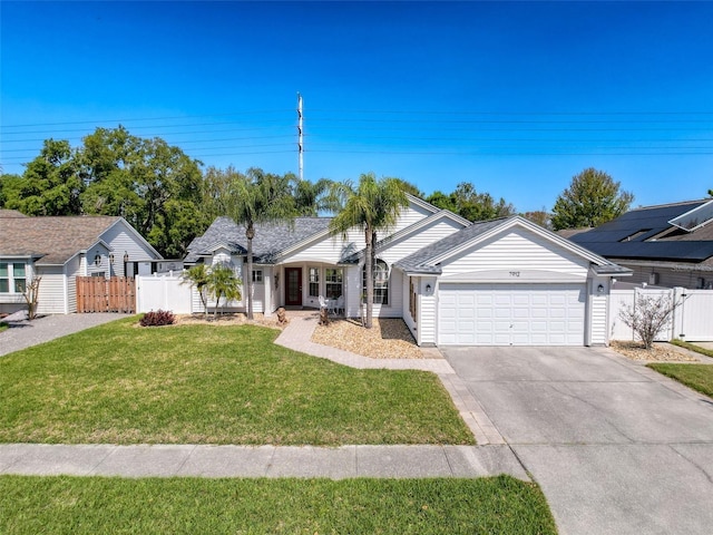 view of front of home featuring a front lawn, fence, driveway, an attached garage, and a gate