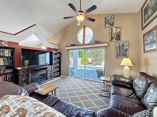 carpeted living room featuring high vaulted ceiling, a ceiling fan, baseboards, and a textured ceiling