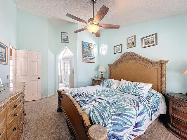 bedroom featuring a textured ceiling, arched walkways, carpet flooring, lofted ceiling, and ceiling fan