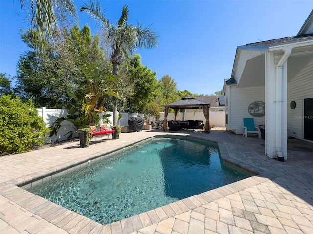 view of swimming pool featuring a gazebo, a patio area, a fenced in pool, and a fenced backyard