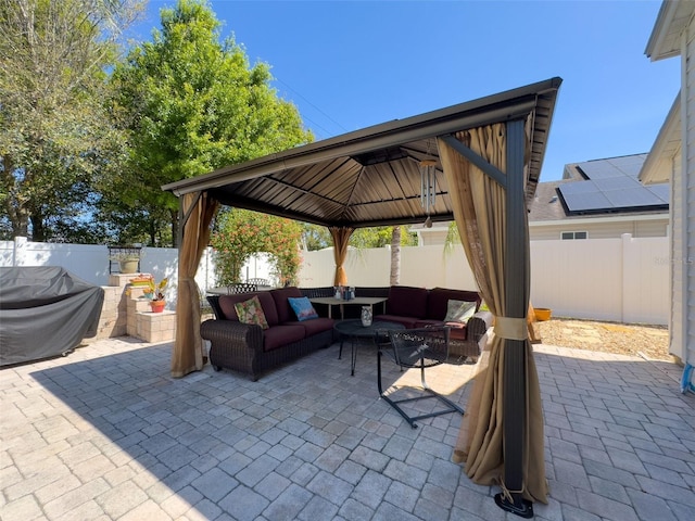 view of patio / terrace with a gazebo, a fenced backyard, and an outdoor hangout area