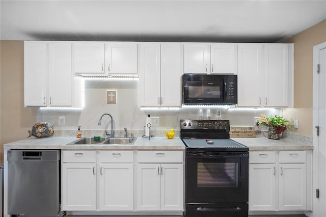 kitchen with black appliances, a sink, light countertops, and white cabinets