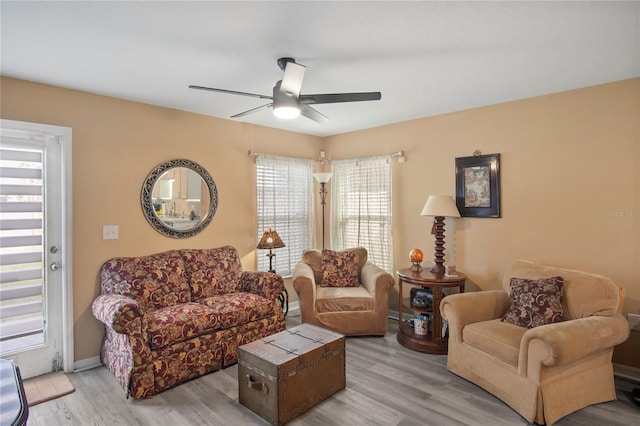 living room featuring ceiling fan and light wood finished floors