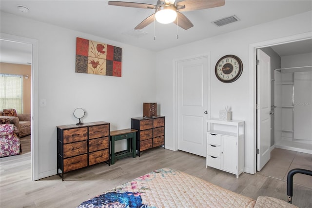 bedroom with light wood-style flooring, visible vents, and baseboards