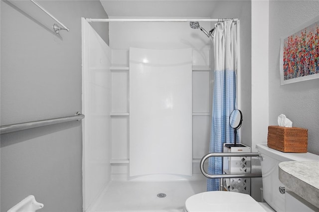 full bathroom featuring a shower stall and toilet