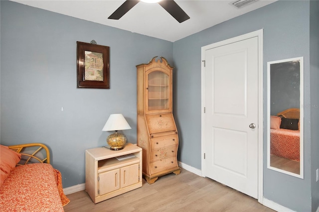 sitting room with baseboards, visible vents, ceiling fan, and light wood finished floors