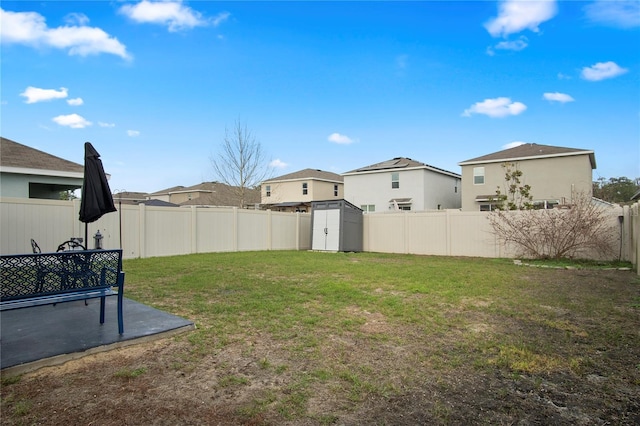 view of yard with a shed, a patio, a fenced backyard, and an outdoor structure