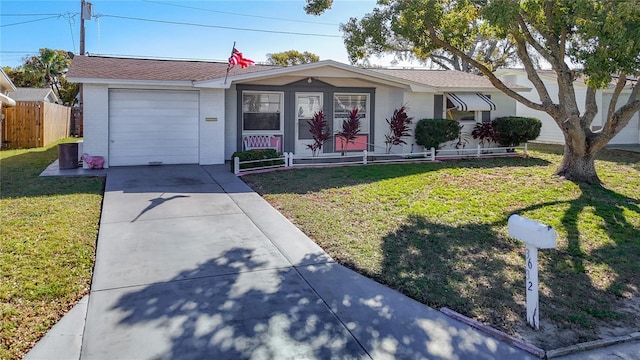 ranch-style home with a garage, covered porch, fence, driveway, and a front lawn