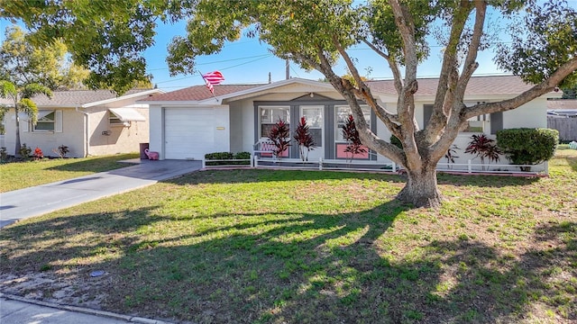 ranch-style home with a garage, a front lawn, and concrete driveway