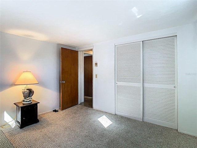 unfurnished bedroom featuring a closet and carpet flooring