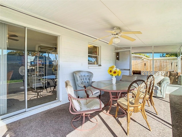 sunroom featuring a ceiling fan