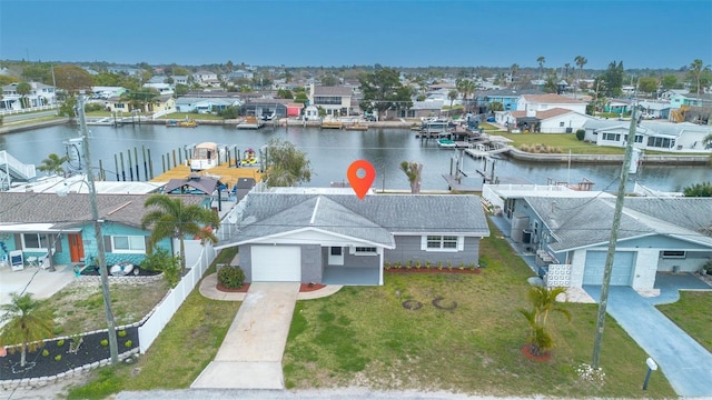 drone / aerial view featuring a residential view and a water view