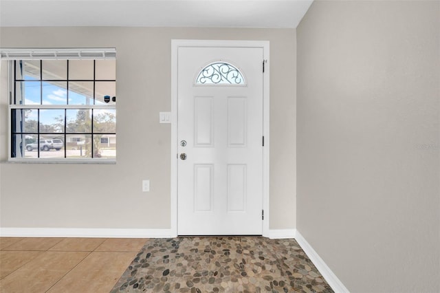 tiled entryway with baseboards