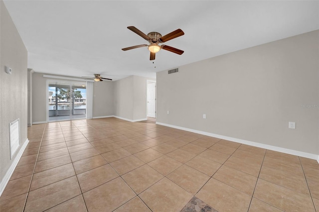 spare room with light tile patterned floors, baseboards, and visible vents