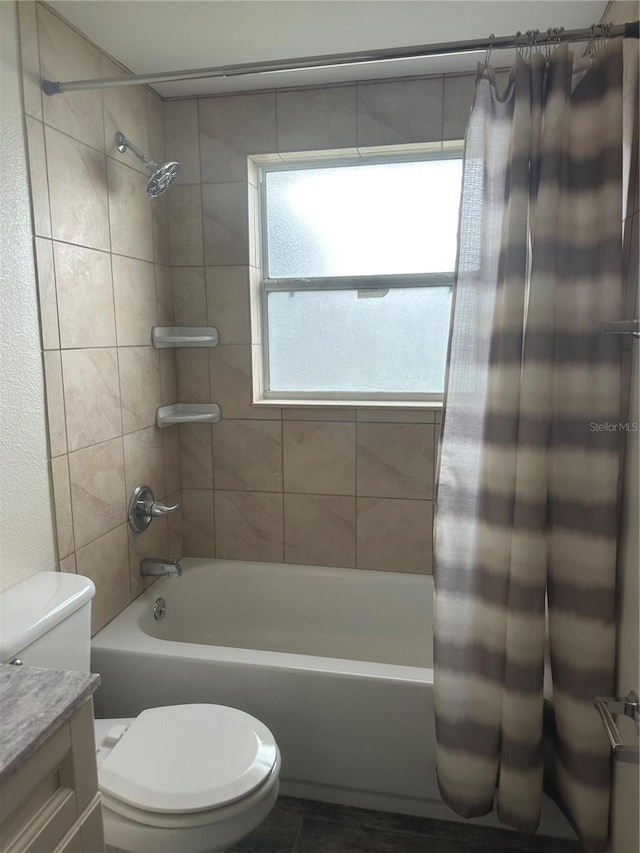 full bath with shower / bath combo with shower curtain, toilet, and vanity