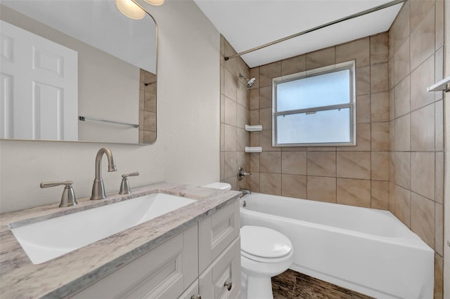 bathroom with vanity, toilet, and shower / tub combination