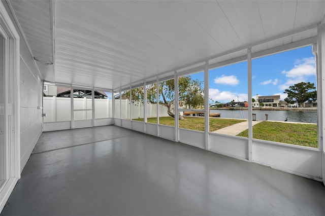 unfurnished sunroom with a water view