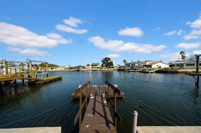 view of dock featuring a water view and a residential view