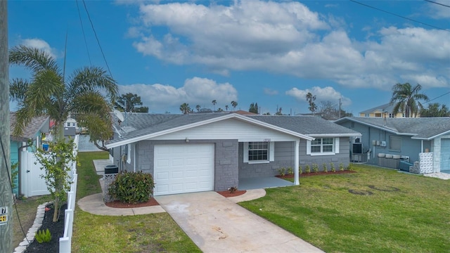 ranch-style home with a front yard, concrete driveway, a garage, and roof with shingles