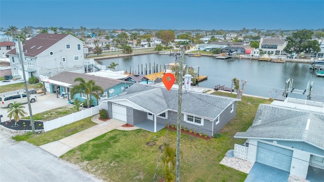 drone / aerial view featuring a residential view and a water view