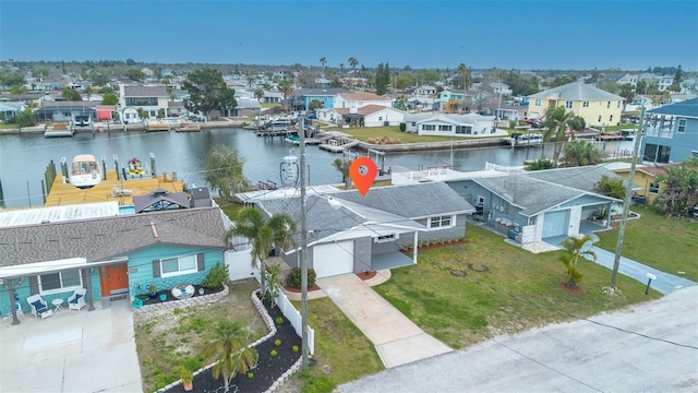 drone / aerial view with a residential view and a water view