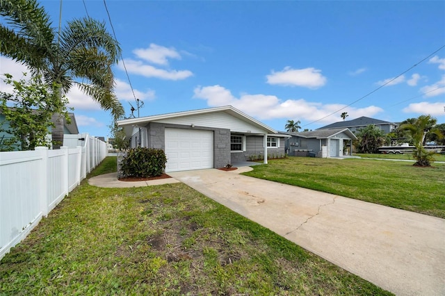 view of front of home with a front lawn, stone siding, fence, concrete driveway, and an attached garage