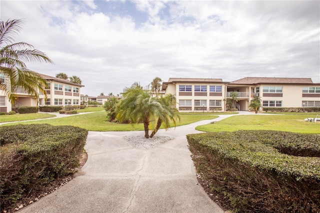 view of property's community with a yard