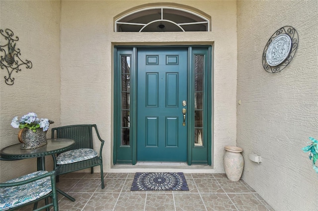 entrance to property with stucco siding