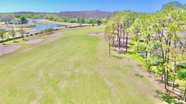 bird's eye view featuring view of golf course and a water view