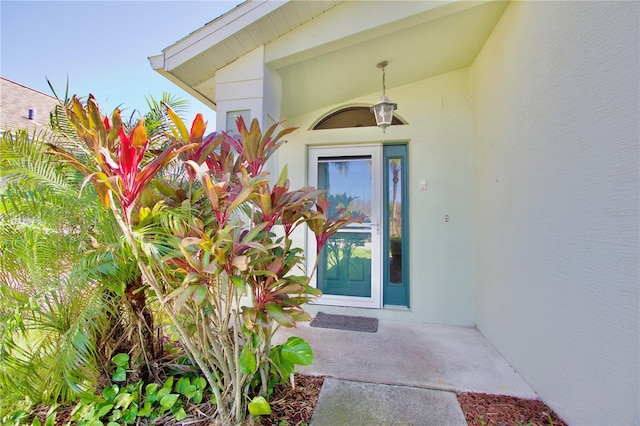 doorway to property with stucco siding