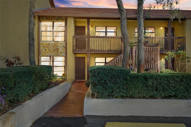 property at dusk featuring stairs