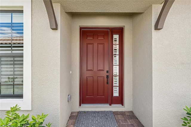 doorway to property with stucco siding