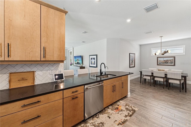 kitchen featuring light wood finished floors, visible vents, decorative backsplash, a sink, and dishwasher