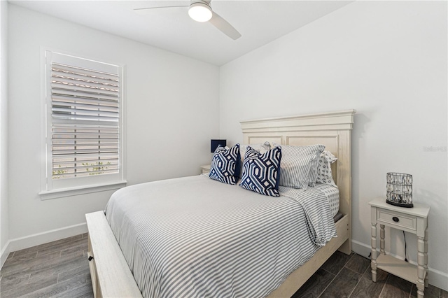 bedroom featuring ceiling fan, baseboards, and wood finished floors